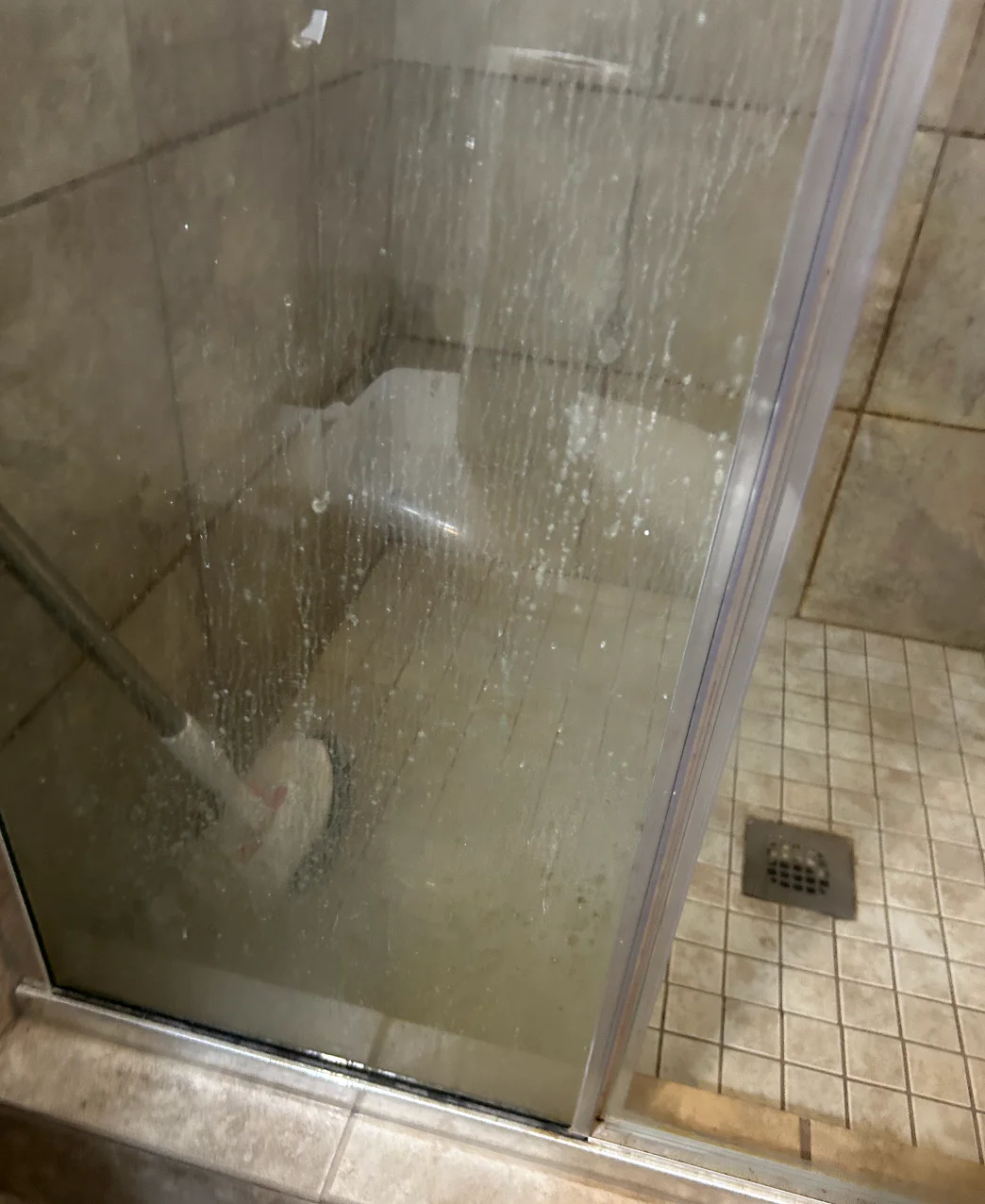 Second angle of the glass shower before detail cleaning